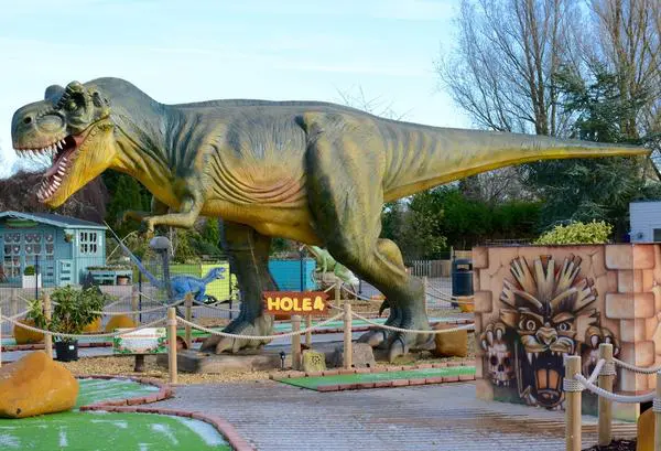 dinosaur on a mini golf course dinosaur on a mini golf course
